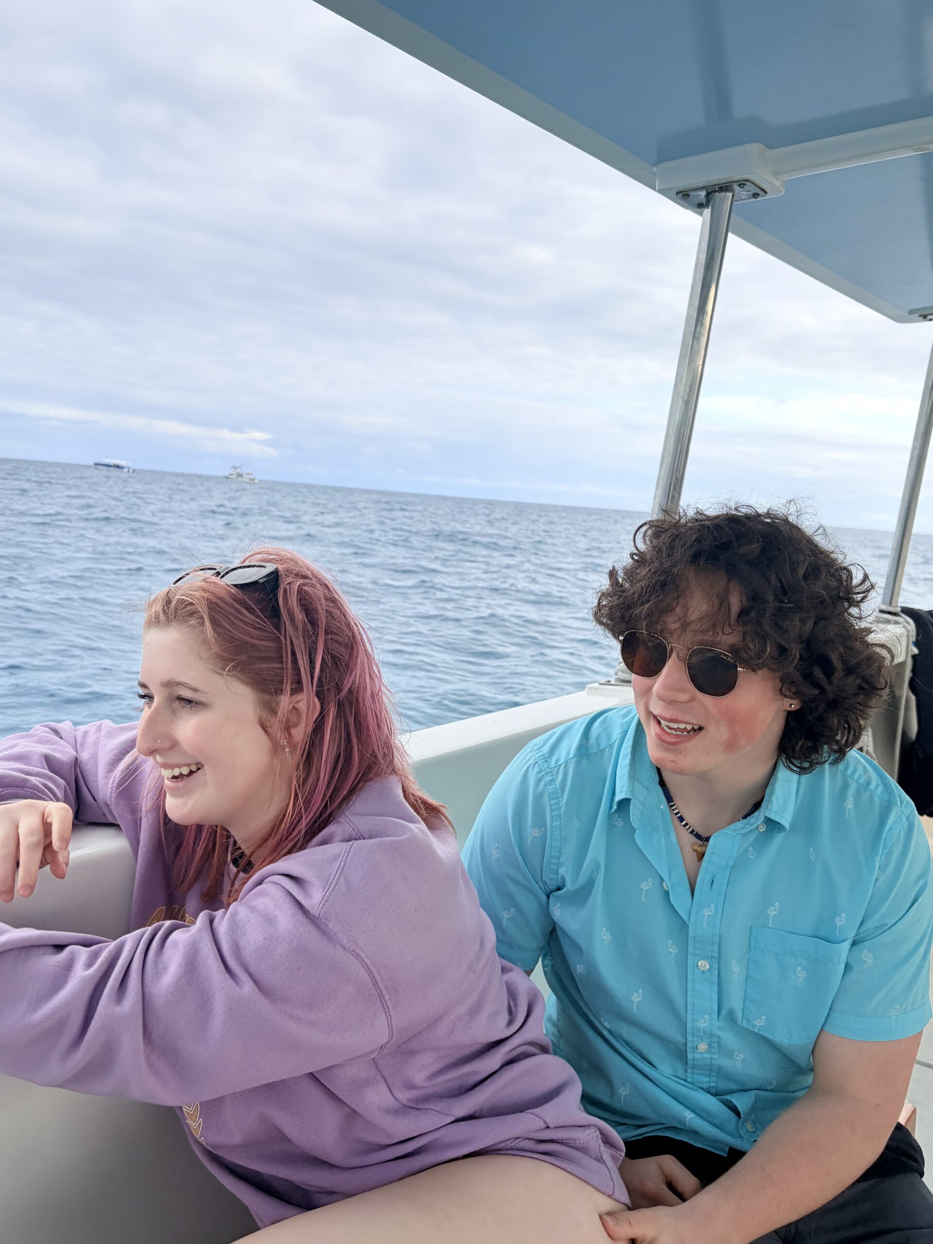 My son and his girlfriend sitting together on a boat during our Florida vacation, enjoying time on the water.